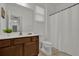 Bright bathroom featuring a toilet and vanity with a white countertop and a white shower curtain at 4571 Cabello Loop, Kissimmee, FL 34746