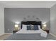 Spacious bedroom features a cozy bed with lamps, accent wall, and decorative pillows at 4571 Cabello Loop, Kissimmee, FL 34746