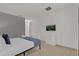 Bright bedroom features a television, a dresser, and bed with a gray accent wall at 4571 Cabello Loop, Kissimmee, FL 34746