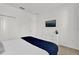 Bright bedroom features a white dresser, tv, closet and a cozy bed with blue patterned blanket at 4571 Cabello Loop, Kissimmee, FL 34746