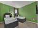 Green bedroom featuring two beds, each adorned with plush pillows and black accents at 4571 Cabello Loop, Kissimmee, FL 34746