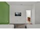 Spacious room with wall-mounted TV and doorway leading to a bathroom at 4571 Cabello Loop, Kissimmee, FL 34746