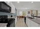 Modern kitchen with granite countertops, stainless steel appliances, and an open floor plan at 4571 Cabello Loop, Kissimmee, FL 34746