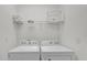 Practical laundry room featuring a washer and dryer, with storage on the shelving above at 4571 Cabello Loop, Kissimmee, FL 34746
