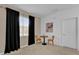 Relaxing sitting area with two chairs, black curtains, and a carpeted floor at 4571 Cabello Loop, Kissimmee, FL 34746