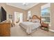 Spacious bedroom with a king-size bed and large windows at 9664 Weatherstone Ct, Windermere, FL 34786