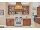 Kitchen with Wolf range, custom cabinetry, and copper range hood at 9664 Weatherstone Ct, Windermere, FL 34786