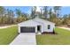 Inviting single-story home with a black front door, modern facade, and well-kept lawn at 12220 Sw 76Th Ln, Dunnellon, FL 34432