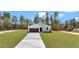 Aerial view of home with long drive, expansive lawns, and wooded surroundings at 12220 Sw 76Th Ln, Dunnellon, FL 34432