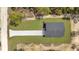 Aerial view of a modern home with a long driveway and green lawn surrounded by trees at 12386 Sw 89Th St, Dunnellon, FL 34432