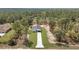 Areal view of the home showcasing the long driveway and large lot surrounded by a dense forest landscape at 12386 Sw 89Th St, Dunnellon, FL 34432