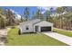 Charming single-story home featuring a modern farmhouse design, well-manicured lawn, and attached two-car garage at 12386 Sw 89Th St, Dunnellon, FL 34432