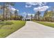 A long driveway leads up to this inviting home nestled among mature trees, complemented by a well-kept green lawn at 12386 Sw 89Th St, Dunnellon, FL 34432