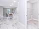 Open-concept featuring kitchen area and laundry room with neutral walls, tile floor, and modern design at 12386 Sw 89Th St, Dunnellon, FL 34432