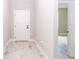 Light and airy hallway with tile floors, white walls, and doors leading to other rooms in the home at 12386 Sw 89Th St, Dunnellon, FL 34432