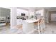 Bright kitchen features white cabinets, stainless steel appliances, and a stylish island with seating at 12386 Sw 89Th St, Dunnellon, FL 34432