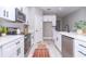 Modern kitchen features white cabinets, stainless steel appliances, and a stylish black faucet at 12386 Sw 89Th St, Dunnellon, FL 34432
