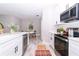 Bright kitchen boasts white cabinets, stainless steel appliances, and a view into the adjacent dining area at 12386 Sw 89Th St, Dunnellon, FL 34432