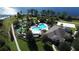 Aerial view of community amenities including pool, mini golf, clubhouse, and sand volleyball court near a beautiful lake at 15531 Waterleigh Cove Dr, Winter Garden, FL 34787