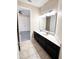 Bathroom featuring double vanity sinks, ample counter space and neutral tile flooring at 15531 Waterleigh Cove Dr, Winter Garden, FL 34787