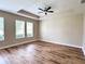 Bedroom showcasing wood flooring, lots of natural light, a trey ceiling, and neutral paint colors at 15531 Waterleigh Cove Dr, Winter Garden, FL 34787