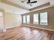 Bedroom showcasing wood flooring, lots of natural light, a trey ceiling, and neutral paint colors at 15531 Waterleigh Cove Dr, Winter Garden, FL 34787