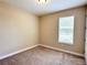 Well-lit carpeted bedroom with a window providing natural light at 15531 Waterleigh Cove Dr, Winter Garden, FL 34787