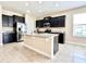 Modern kitchen featuring granite countertops, stainless steel appliances, and black cabinets at 15531 Waterleigh Cove Dr, Winter Garden, FL 34787