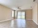 Spacious living room featuring tile flooring, neutral walls, and sliding glass doors to the outside at 15531 Waterleigh Cove Dr, Winter Garden, FL 34787