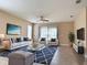 Comfortable living room featuring stylish furnishings, tile floors, and large sliding doors to the outside at 15531 Waterleigh Cove Dr, Winter Garden, FL 34787