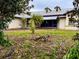 House with a walkway and small palm tree in front at 22711 State Road 44, Eustis, FL 32736