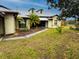 One-story home with a walkway leading to the entrance and mature landscaping at 22711 State Road 44, Eustis, FL 32736