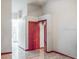 Clean hallway with tiled floors and red doors at 22711 State Road 44, Eustis, FL 32736