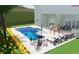Backyard pool with in-pool seating, sun loungers, outdoor seating, and lush landscaping at 3867 Grassland Loop, Lake Mary, FL 32746