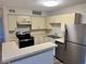 Modern kitchen with stainless steel appliances, ample counter space, and bright lighting at 485 Forestway Cir # 202, Altamonte Springs, FL 32701