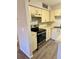 Modern kitchen featuring stainless steel appliances, wood-style flooring, and neutral color palette at 485 Forestway Cir # 202, Altamonte Springs, FL 32701