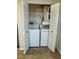 Functional laundry room with a stacked washer and dryer and added storage space at 485 Forestway Cir # 202, Altamonte Springs, FL 32701