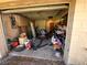 Cluttered garage interior featuring tools, storage shelves, and various equipment at 6301 State Road 60 E, Bartow, FL 33830