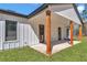 Covered back patio with wooden pillars, white siding, and an outdoor living space at 8827 Sw 137Th Ct, Dunnellon, FL 34432