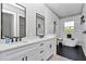 Stylish bathroom with dual sinks, black accents, subway tile, and a standalone soaking tub at 8827 Sw 137Th Ct, Dunnellon, FL 34432
