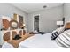 Bedroom featuring woven furniture, decorative mirror, and a glimpse into the ensuite bathroom at 8827 Sw 137Th Ct, Dunnellon, FL 34432