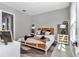 Cozy bedroom showcasing a rattan bed frame, stylish decor, and natural light at 8827 Sw 137Th Ct, Dunnellon, FL 34432