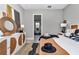 Bedroom featuring woven furniture, decorative mirror, and a glimpse into the ensuite bathroom at 8827 Sw 137Th Ct, Dunnellon, FL 34432