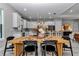 Dining area featuring a wooden table, black chairs, and a view of the modern kitchen at 8827 Sw 137Th Ct, Dunnellon, FL 34432