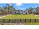 Charming white farmhouse with black trim, wooden columns and a spacious manicured front lawn at 8827 Sw 137Th Ct, Dunnellon, FL 34432