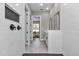 Hallway view showing stylish bathroom with tub and dual sink vanity in the distance at 8827 Sw 137Th Ct, Dunnellon, FL 34432