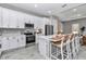 Well-equipped kitchen featuring modern appliances, stylish cabinetry, and a center island with bar seating at 8827 Sw 137Th Ct, Dunnellon, FL 34432