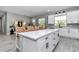 Spacious kitchen island offering seating with modern barstools and contemporary fixtures at 8827 Sw 137Th Ct, Dunnellon, FL 34432