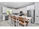 Modern kitchen with white cabinets, stainless steel appliances, and a large island with seating at 8827 Sw 137Th Ct, Dunnellon, FL 34432