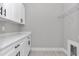 Functional laundry room featuring white cabinets, counter space, and a clean design, maximizing utility at 8827 Sw 137Th Ct, Dunnellon, FL 34432